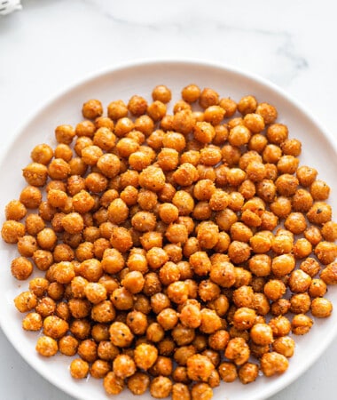Flat lay shot of a batch of crispy air fryer chickpeas in a white bowl