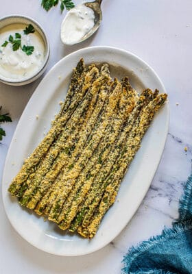 Top view of healthy asparagus fries in a white oval dish