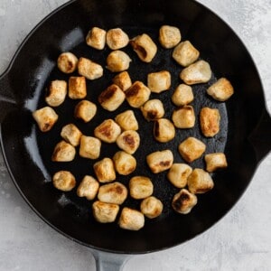 Overhead view of gnocchi getting browned in a skillet