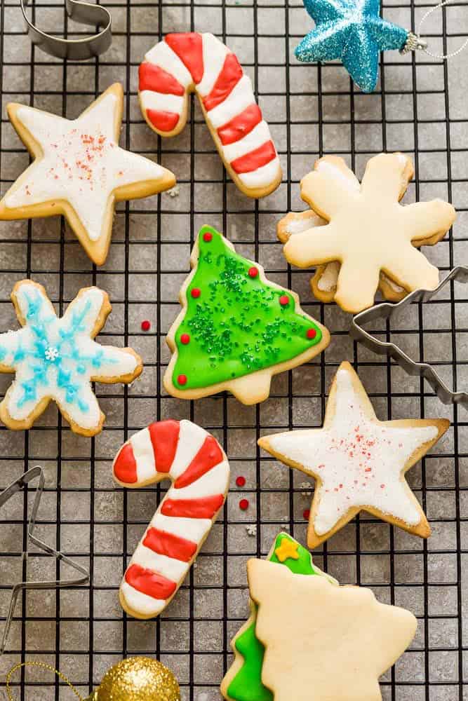 The BEST sugar cookie recipe for making decorated cut out Christmas / holiday shapes with perfect edges. Best of all, these delicious cookies bake up soft, flavorful and are easy to make with a just a few pantry ingredients. Plus instructions on how to decorate with royal icing and tips on how to make amazing cookies that don't spread. Perfect for Santa's cookie tray or holiday parties.