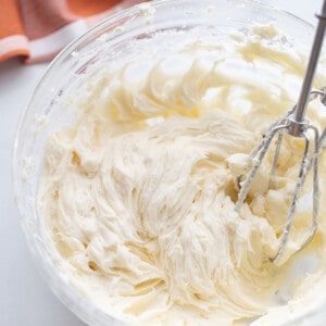 Dairy free buttercream frosting in a glass mixing bowl with beaters