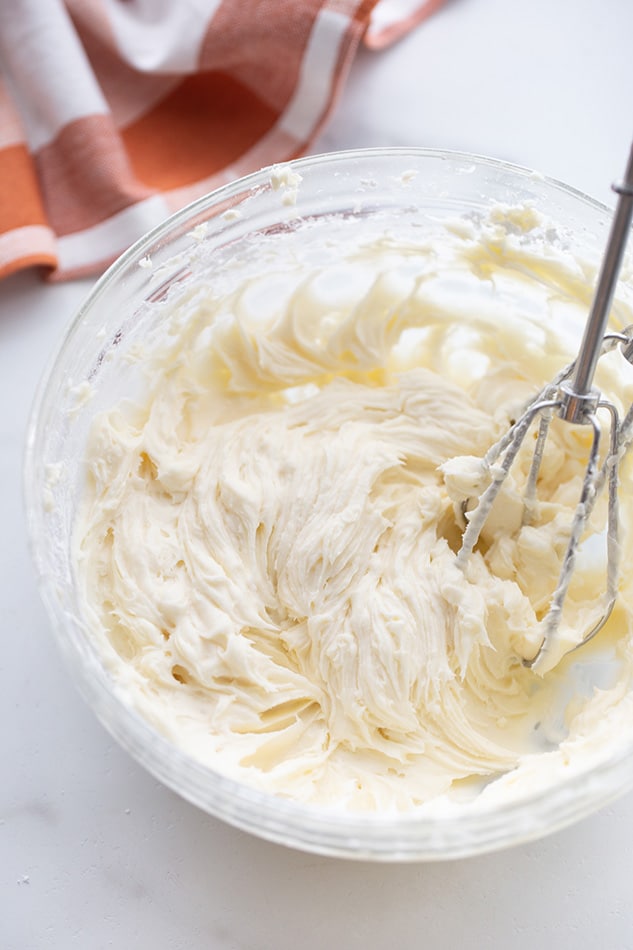 Dairy-free buttercream frosting in a mixing bowl with beaters