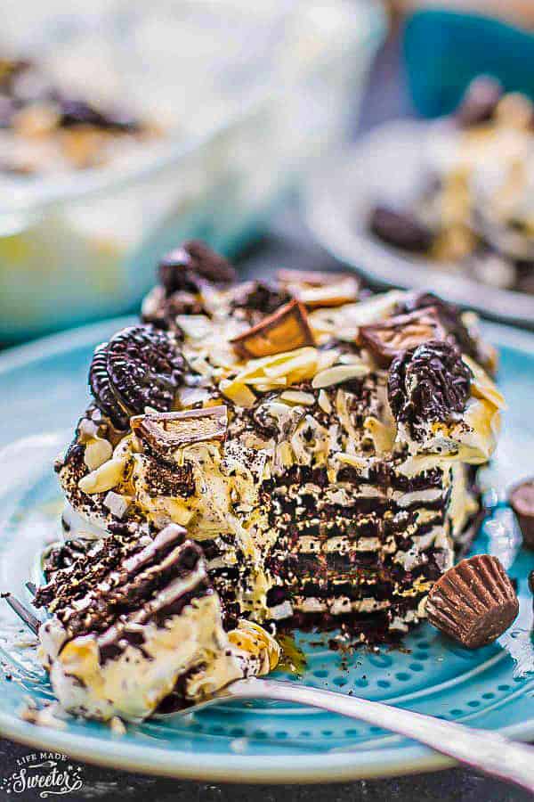 A serving of layered Chocolate Icebox Cake on a plate with a bite on a fork