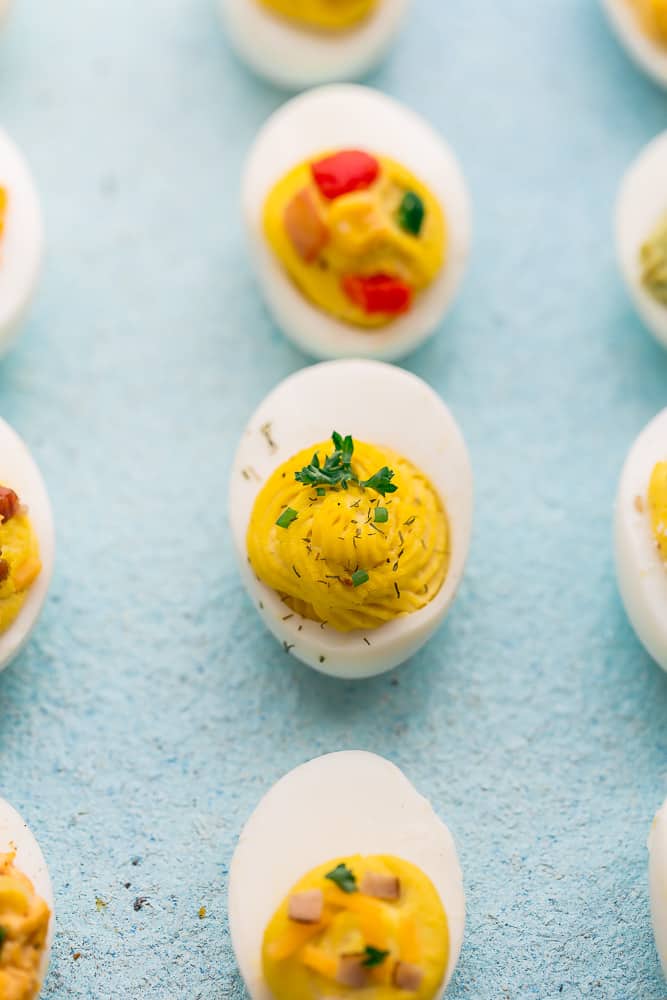 A Classic Deviled Egg Surrounded by Those of Different Flavors