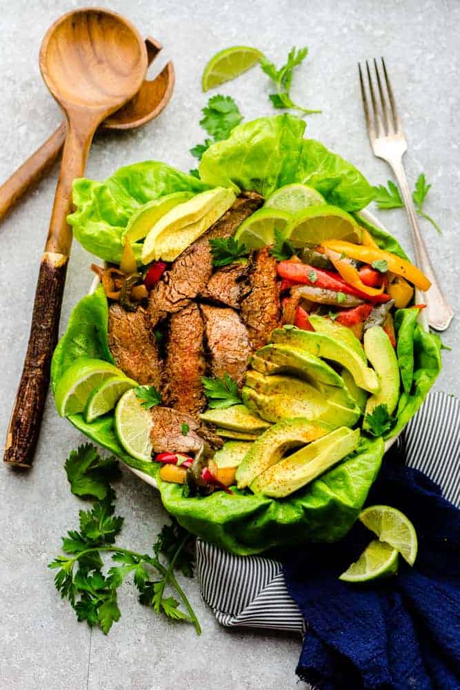 Easy Steak Fajitas are tender, juicy and full of flavor! Best of all, they come together super quick and are perfect for busy weeknights. Marinated in a homemade fajita spice blend and cilantro a delicious Tex-Mex cilantro lime marinade. Low carb and keto friendly serving options and great for meal prepping on Sunday for work or school lunchboxes or lunch bowls.