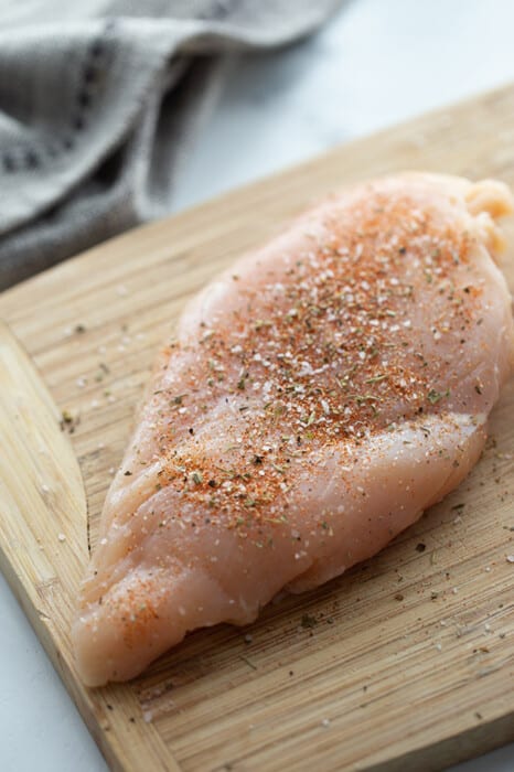 Top view of chicken breast on a cutting board