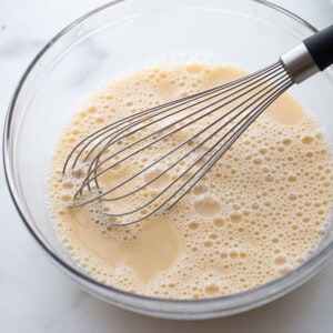 Batter mixture in a mixing bowl with a whisk