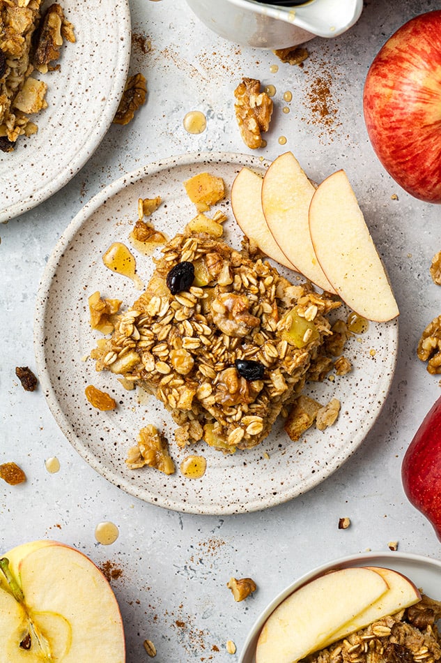 Top view of a square of vegan apple cinnamon baked oatmeal on a white plate