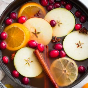 Top view of hot apple cider in a cast iron pot