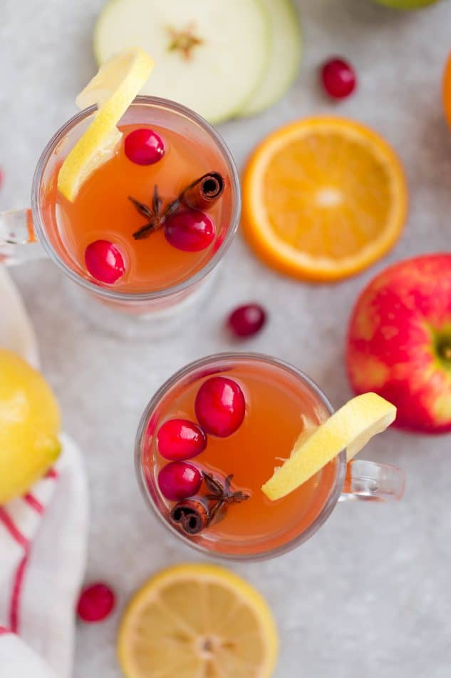 This Easy Homemade Apple Cider Recipe is the perfect easy drink for fall and the holiday season. Best of all, this easy version is made with a blend of juices and infused with apples, orange, lemon, cranberries, cinnamon and cloves. Set and forget and makes your house smell amazing! Warm up with a mug by a cozy fireplace.