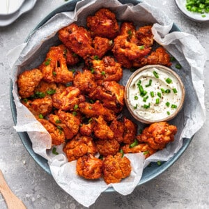 Top view of cauliflower wings in a bowl with ranch dipping sauce