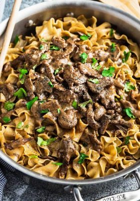 one pan beef stroganoff with mushrooms in a creamy gravy over cooked noodles