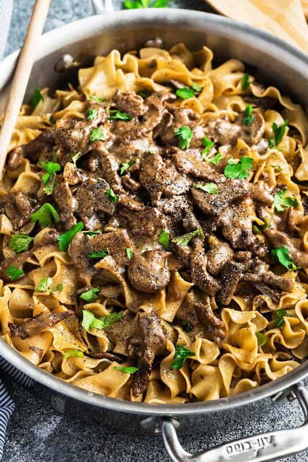 Large skillet of one pot Beef Stroganoff with fresh mushrooms and diced parsley