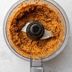 Top view of blended ingredients to make carrot cake protein balls in a food processor
