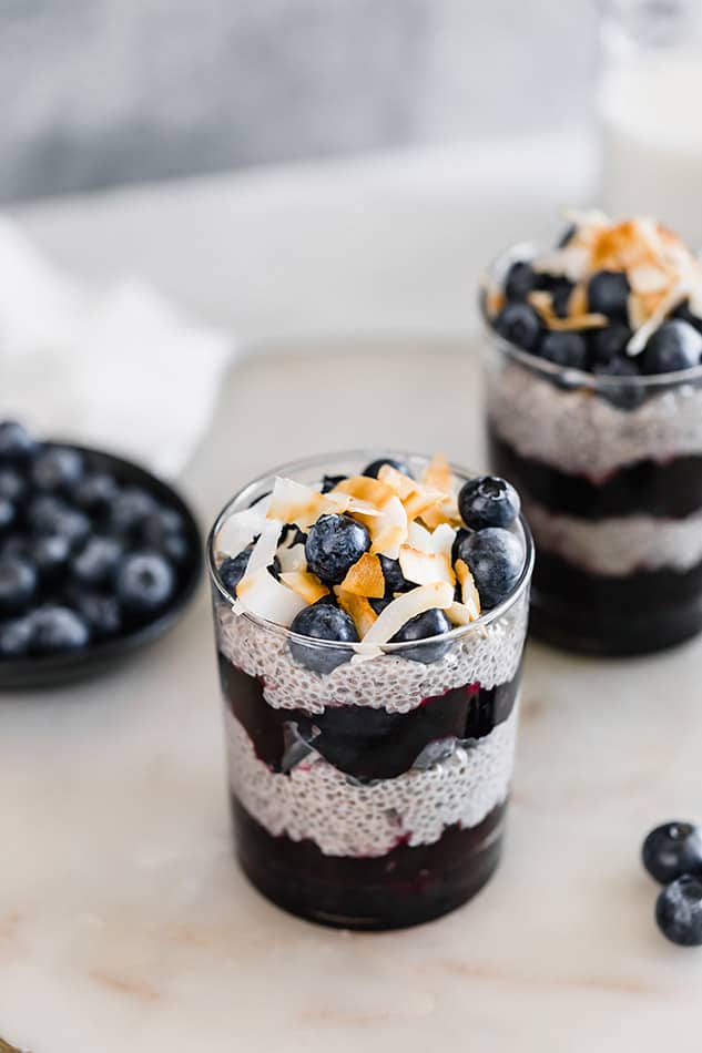 Front view of chia pudding with blueberries in background. 