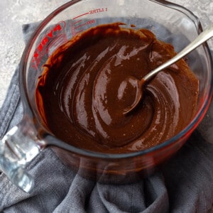 Side view of melted chocolate in a large measuring cup