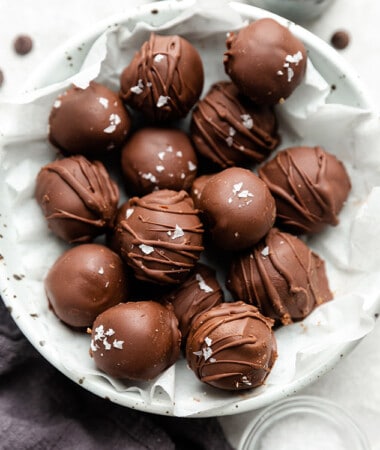 A pile of easy chocolate truffles in a white bowl