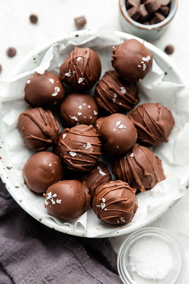 Overhead view of chocolate truffles in a white bowl