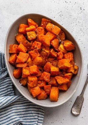Cubed roasted sweet potatoes in a white oval serving platter