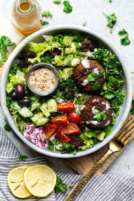Easy Falafel Salad in a white bowl with a gold fork