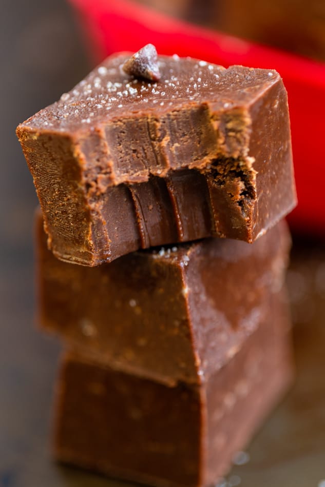 3 pieces of chocolate fudge stacked with a bite out of the top piece