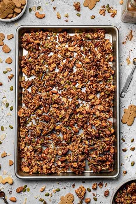 Top view of healthy gingerbread granola on a large baking sheet
