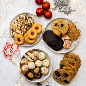 Flat-lay of three plates of various cookies for the holiday cookie box