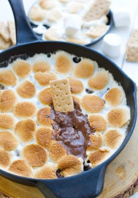 Pan of S'mores dip with graham cracker and chocolate