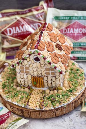 Easy No Bake Gingerbread House - An easy and simple way to make a "gingerbread" house using graham crackers and nuts. It's the perfect holiday activity for the kids and best of all, no baking required!