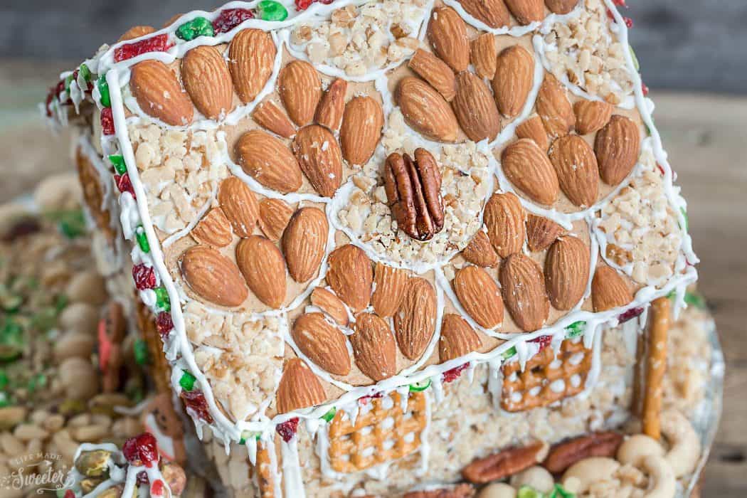 An easy and simple way to make a "gingerbread" house using graham crackers and nuts. It's the perfect holiday activity for the kids and best of all, no baking required!