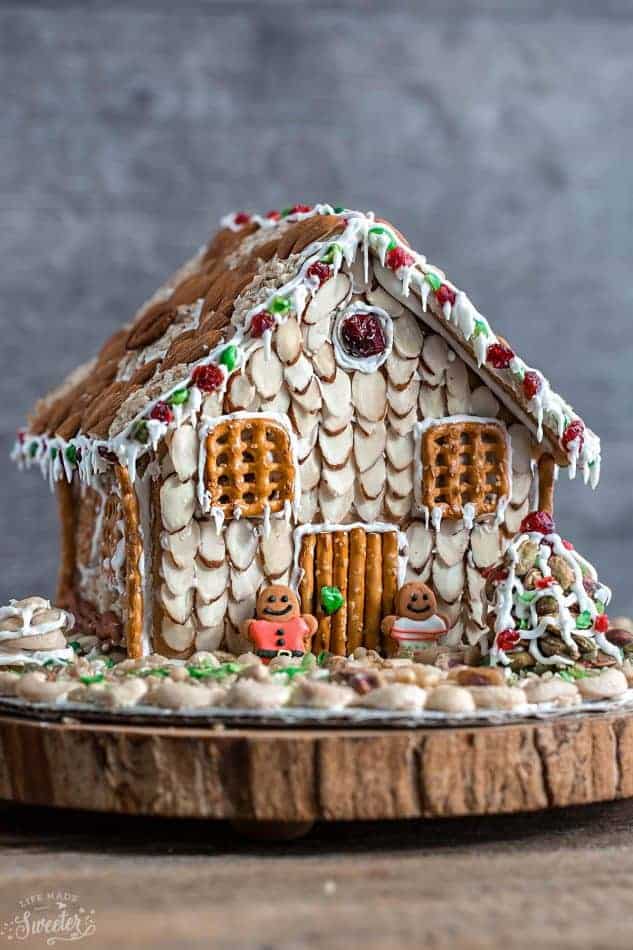 An easy and simple way to make a "gingerbread" house using graham crackers and nuts. It's the perfect holiday activity for the kids and best of all, no baking required!
