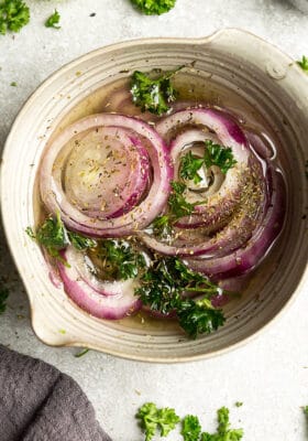 Overhead photo of easy pickled onions garnished with parsley.