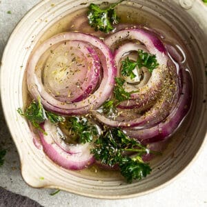 Overhead photo of easy pickled onions garnished with parsley.