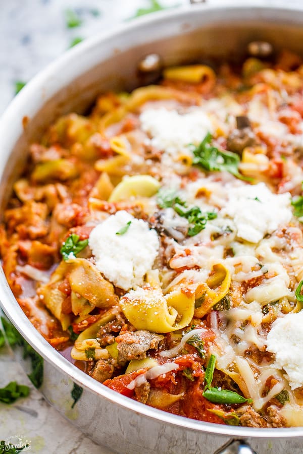 Close-up view of zucchini lasagna in stainless steel skillet.