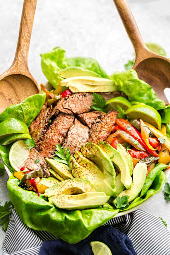 Easy Steak Fajitas are tender, juicy and full of flavor! Best of all, they come together super quick and are perfect for busy weeknights. Marinated in a homemade fajita spice blend and cilantro a delicious Tex-Mex cilantro lime marinade. Low carb and keto friendly serving options and great for meal prepping on Sunday for work or school lunchboxes or lunch bowls.