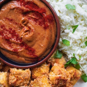 Close-up bowl with tofu nuggets and spicy peanut dip