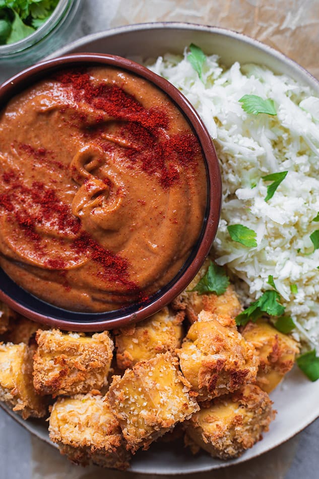 Close-up bowl with tofu nuggets and spicy peanut dip