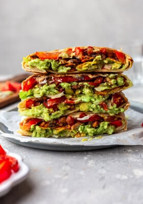 A stack of four vegan crunchwrap halves on a plate