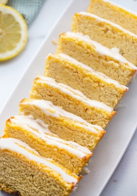 Top view of vegan lemon loaf slices on a white square plate