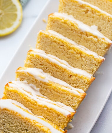Top view of vegan lemon loaf slices on a white square plate