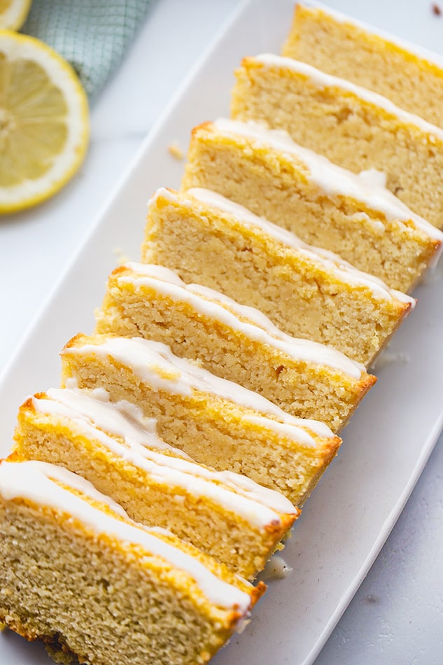 Top view of vegan lemon loaf slices on a white square plate