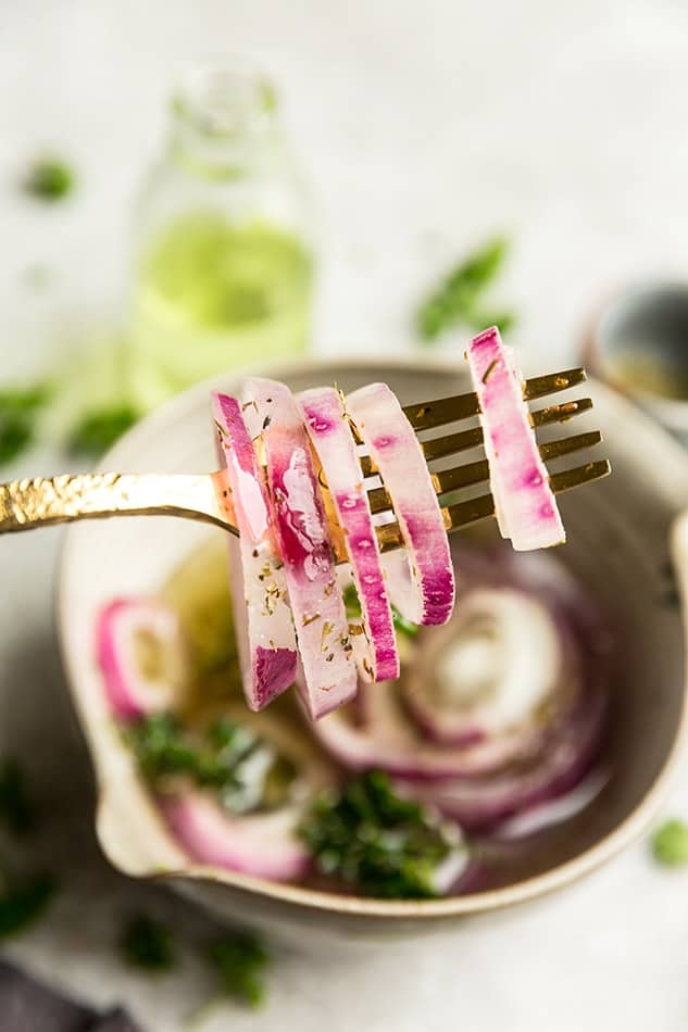Close-up image of easy pickled onions on a fork.