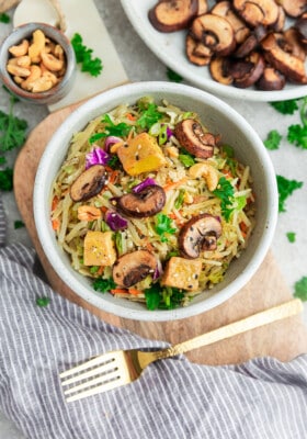 Top view of vegetarian egg roll in a bowl in a white bowl with chopsticks