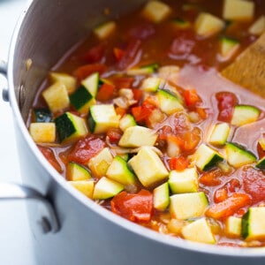 Diced tomatoes, red bell pepper, onion, garlic, zucchini, vegetable broth and taco seasoning in a large stainless steel pot