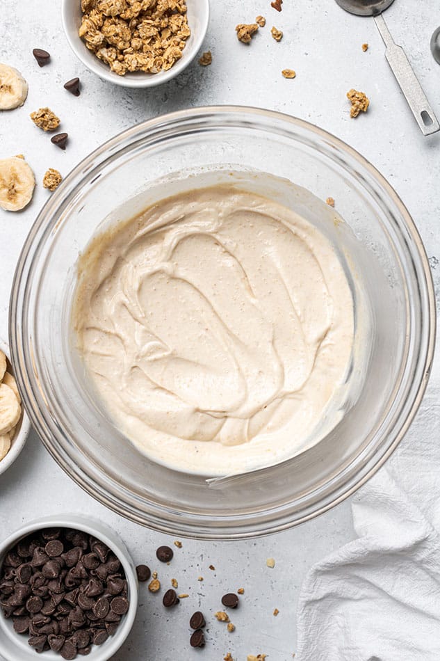 Overhead view of yogurt mixed with cashew butter, protein powder, maple syrup and vanilla.