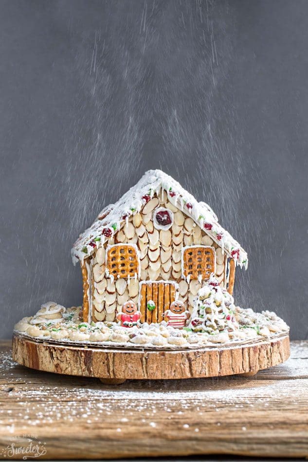 An easy and simple way to make a "gingerbread" house using graham crackers and nuts. It's the perfect holiday activity for the kids and best of all, no baking required!