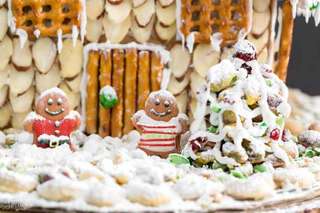 An easy and simple way to make a "gingerbread" house using graham crackers and nuts. It's the perfect holiday activity for the kids and best of all, no baking required!