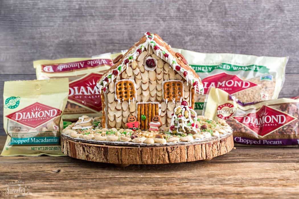 An easy and simple way to make a "gingerbread" house using graham crackers and nuts. It's the perfect holiday activity for the kids and best of all, no baking required!