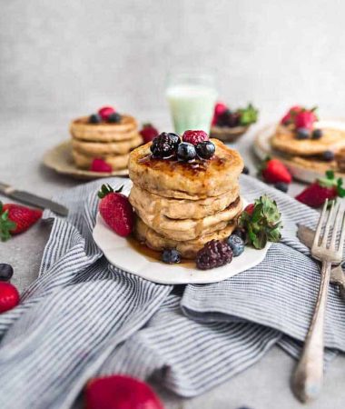 Eggless pancakes on a plate with strawberries, raspberries, blackberries and blueberries