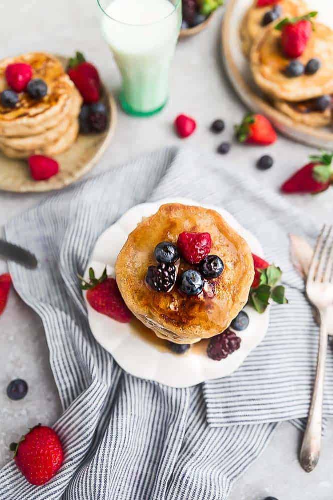 Eggless pancakes on a plate with strawberries, raspberries, blackberries and blueberries